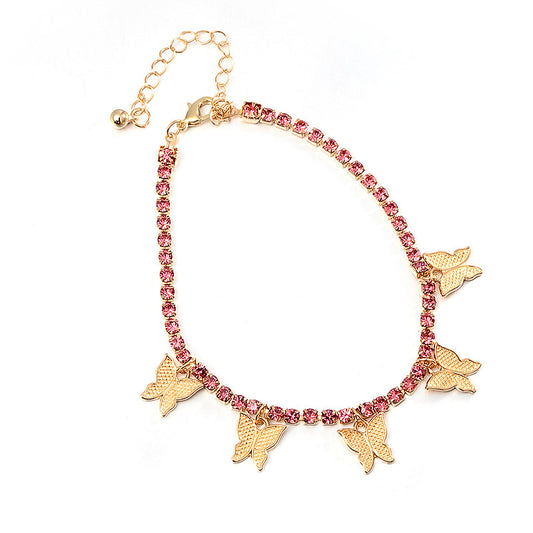 Bracelet with pink gemstones and gold butterfly charms on a white background