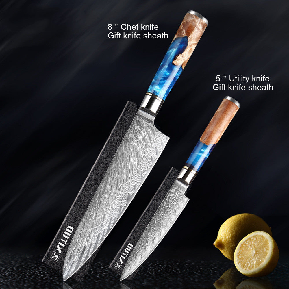 Two knives with decorative handles on a dark background with lemons.