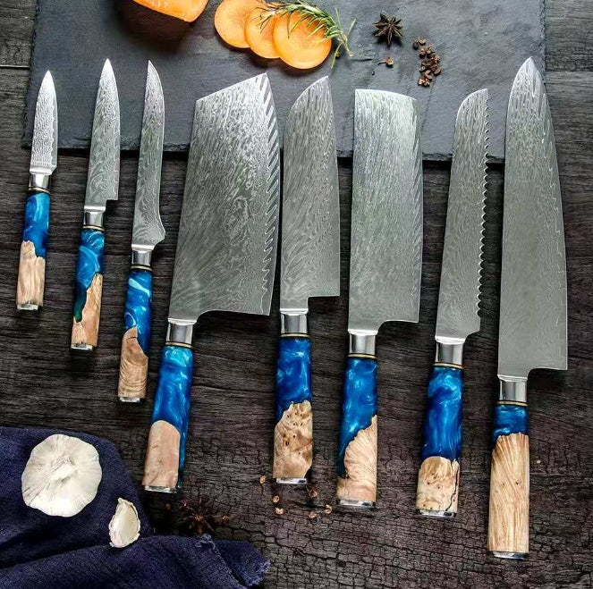 Set of knives with blue and wooden handles on a dark surface