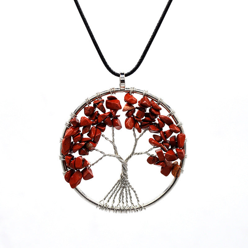 Tree-shaped pendant with red stones on a white background
