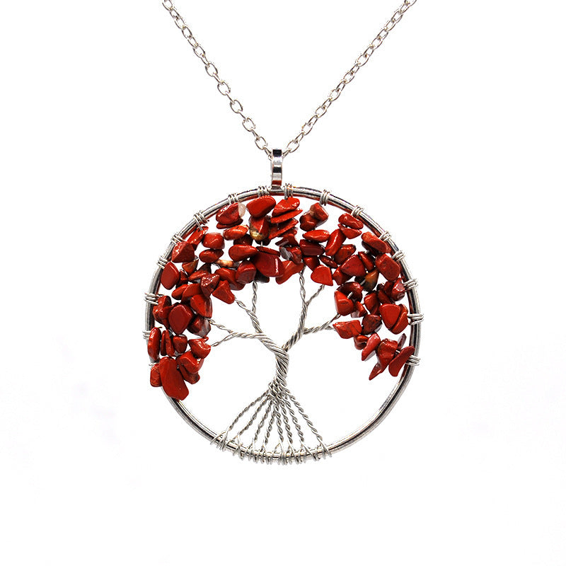 Tree-shaped pendant with red stones on a white background