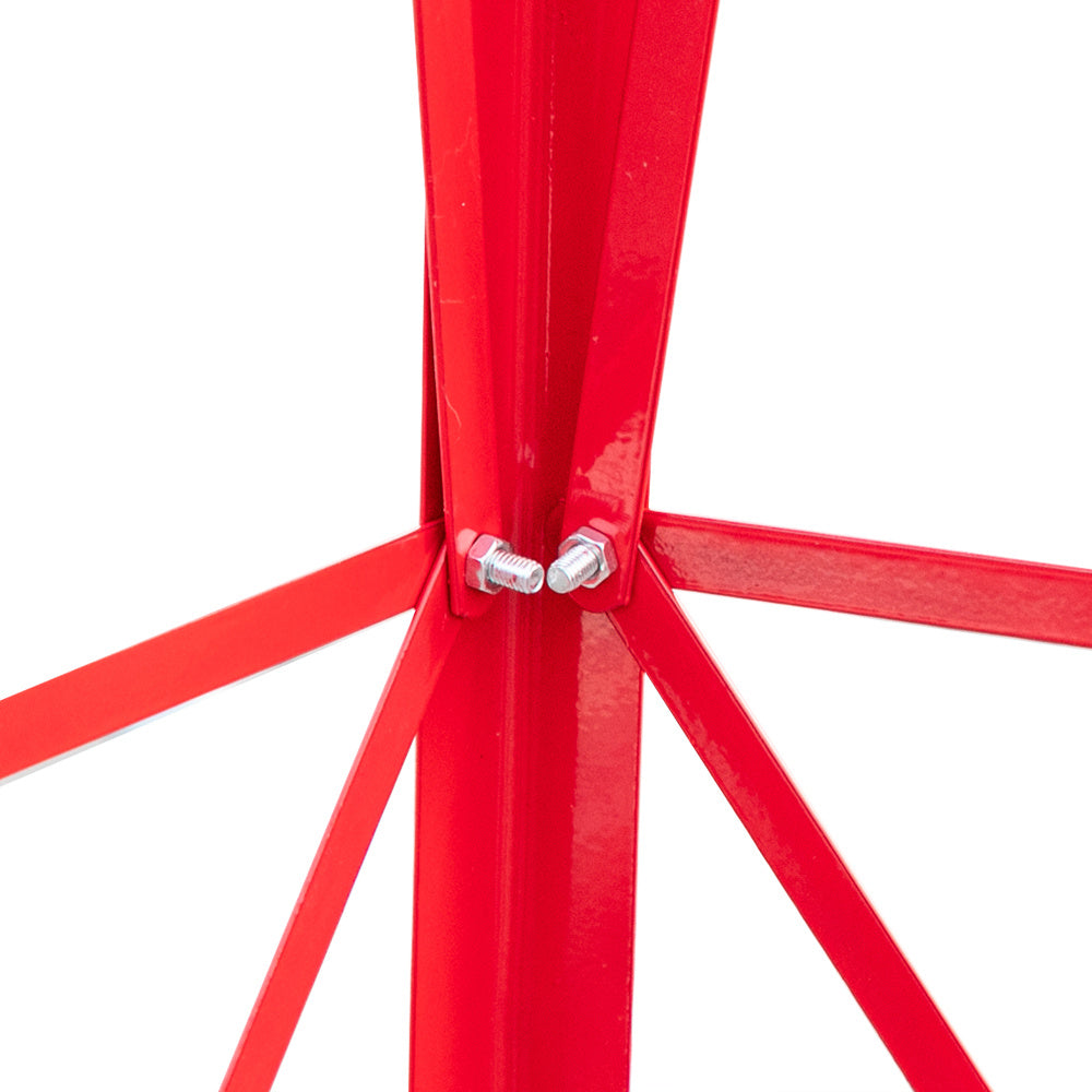 Close-up of a red metal chair frame with bolts on a white background