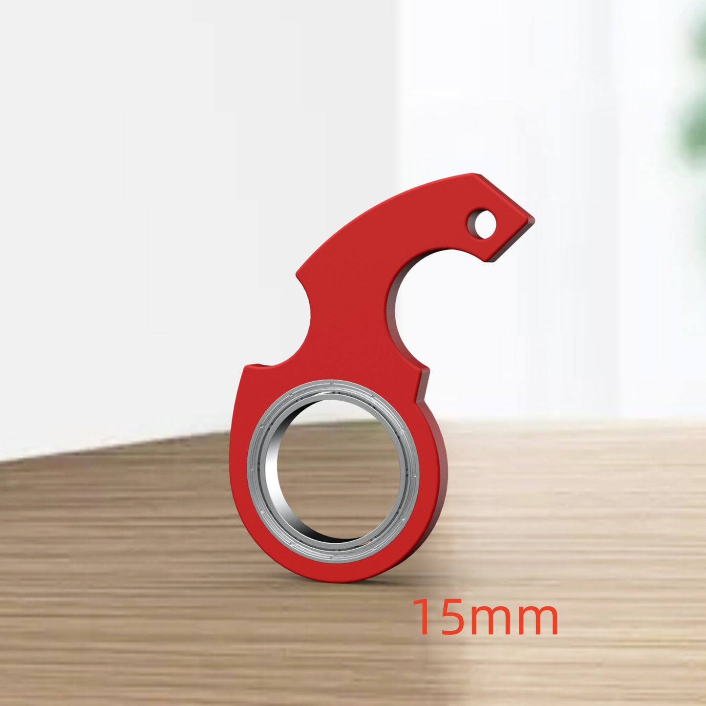Red metal ring with a handle on a wooden surface, labeled '15mm'.