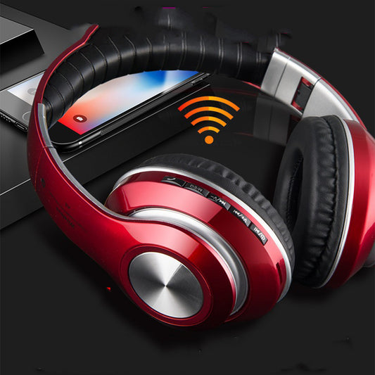 Red and black headphones with a smartphone displaying a music app on a dark background