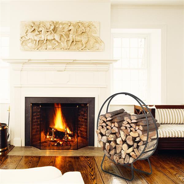 Fireplace with a fire burning and a metal log holder filled with wood in a living room.