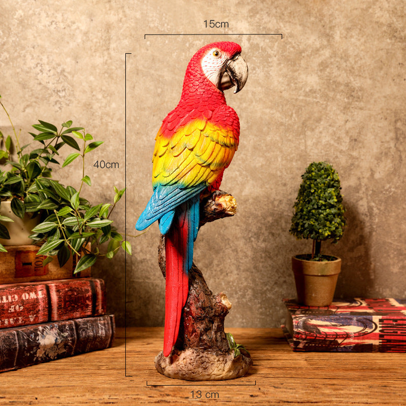 Colorful parrot statue with dimensions on a wooden surface and books in the background