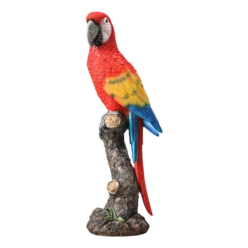 Colorful parrot figurine on a branch with a white background