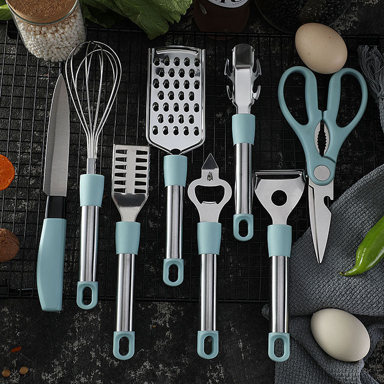 Set of kitchen utensils with blue handles on a dark surface