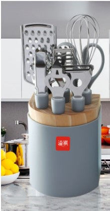 Set of kitchen utensils on a wooden block with a visible brand logo in a kitchen setting.