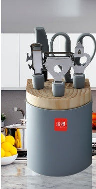 Set of kitchen shears and cutting boards on a wooden block with a visible brand logo.