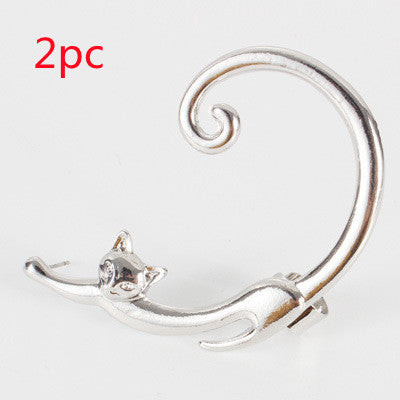 Silver cat-shaped brooch on a white background