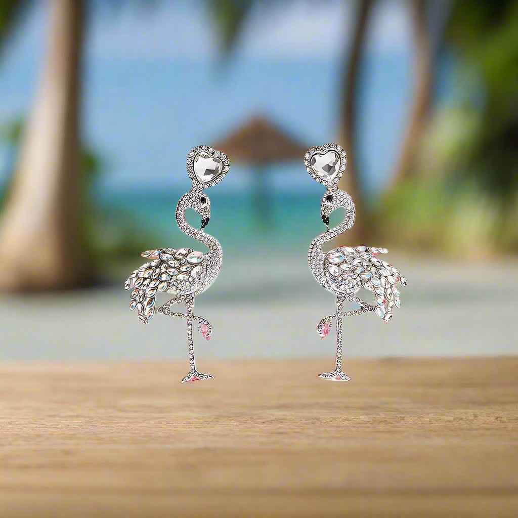 Flamingo-shaped earrings with intricate detailing on a white background