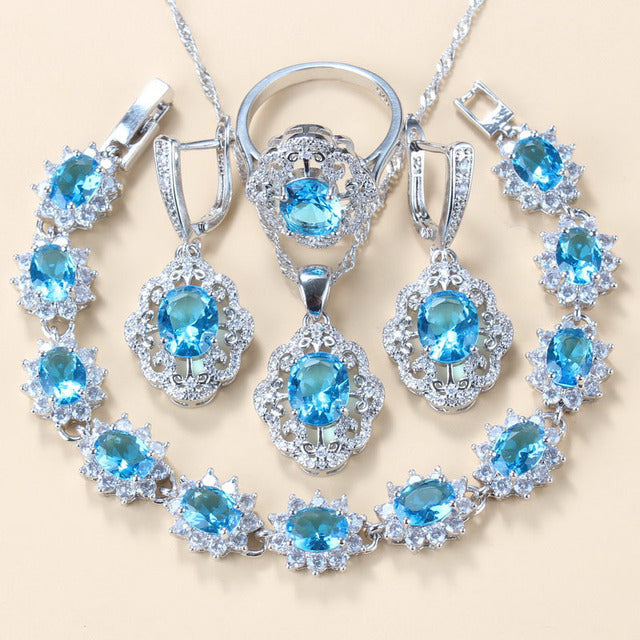 Jewelry set with blue gemstones on a beige background