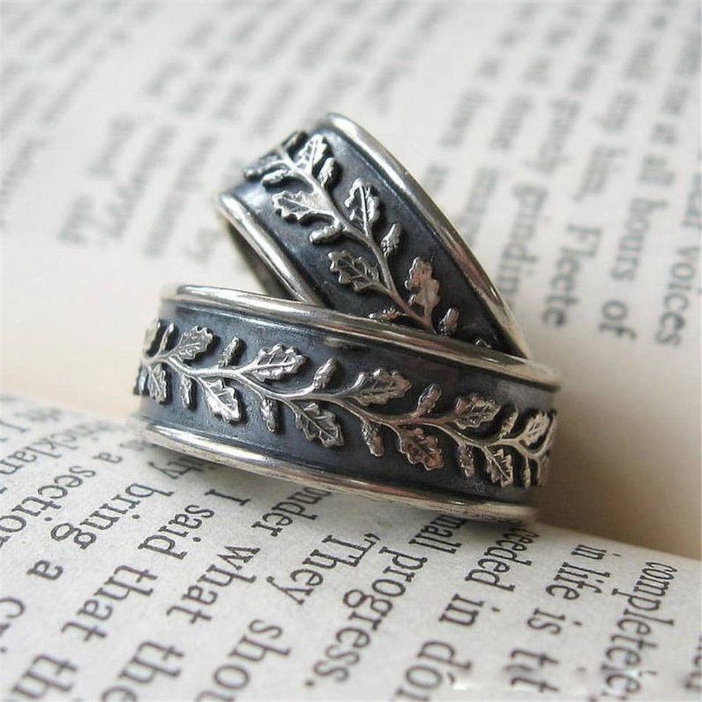 Two silver rings with floral patterns on a piece of paper