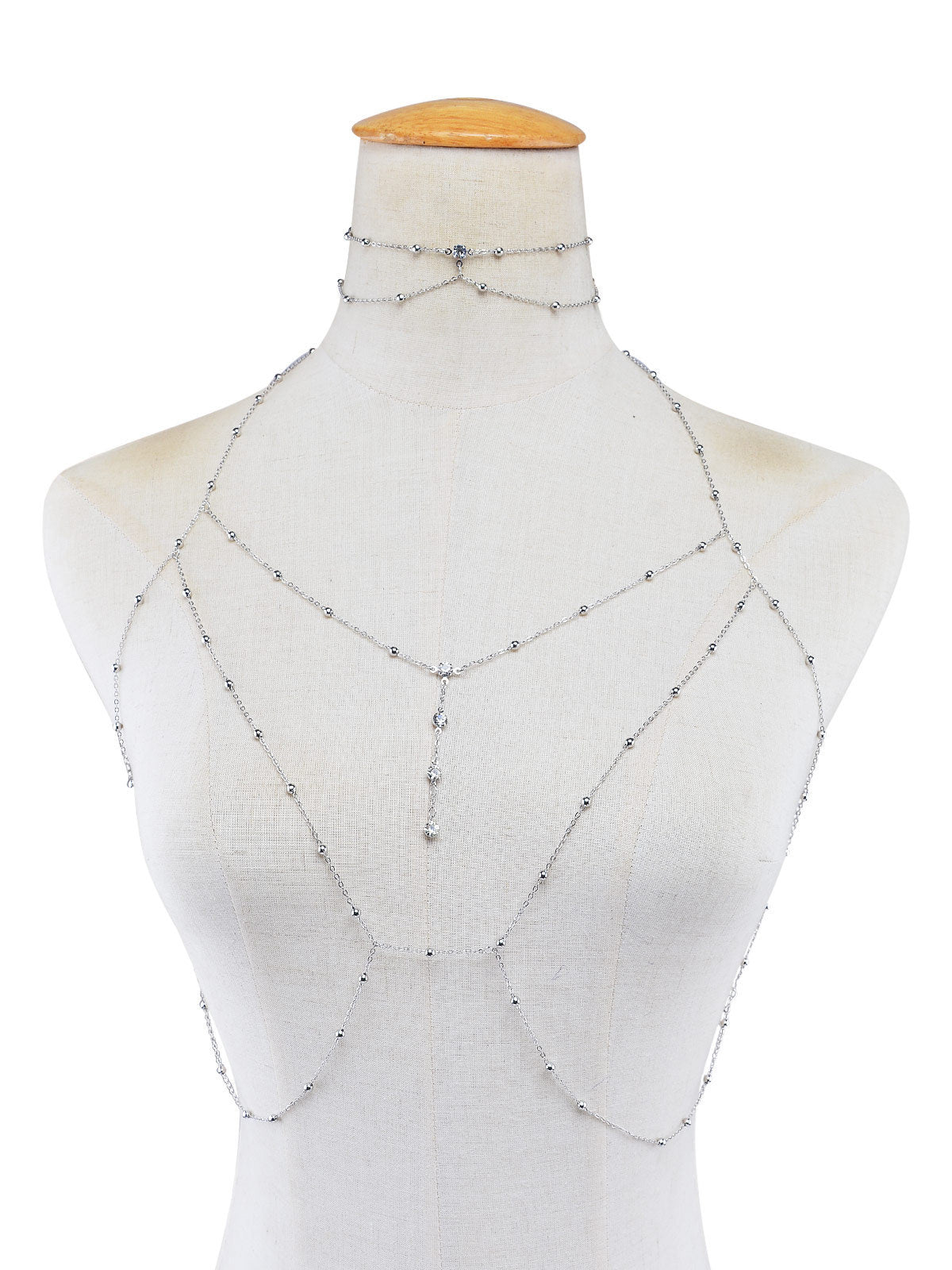 Mannequin wearing a silver chainmaille top on a white background