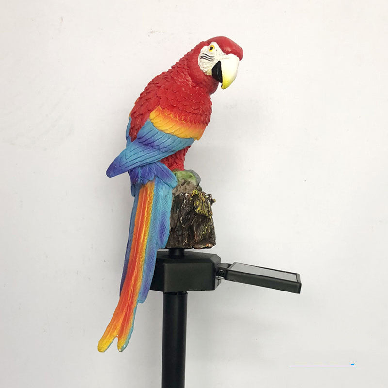 Colorful parrot figurine on a stand against a white background