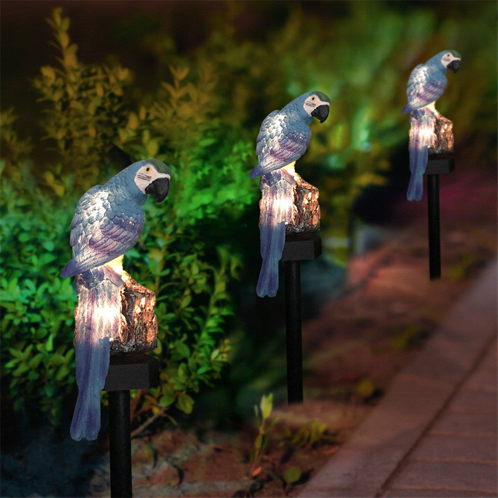 Solar-powered parrot lights on stakes with a garden background