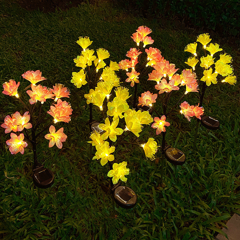 Solar-powered flower lights on grass at night