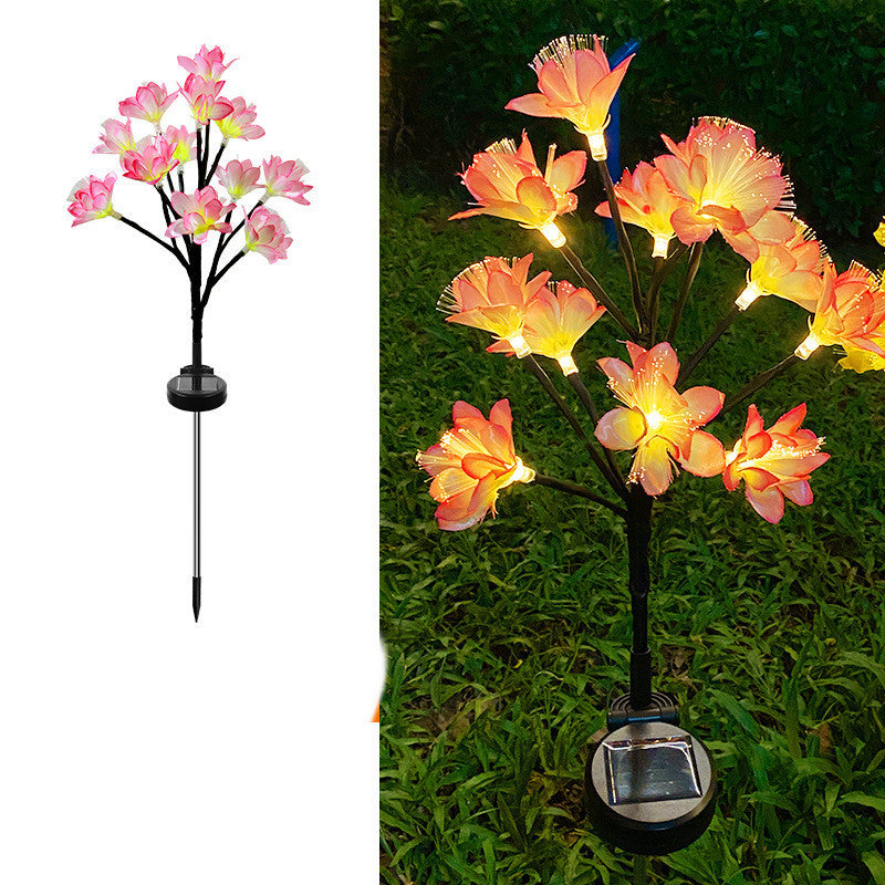 Solar-powered flower light on a white background and in outdoor grass setting.