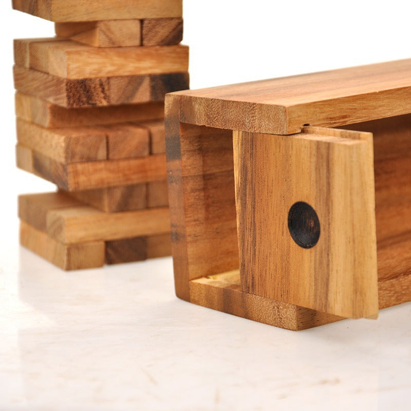 Wooden blocks with one block propped up on a white background