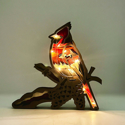 Wooden cardinal bird sculpture with embedded lights on a plain background