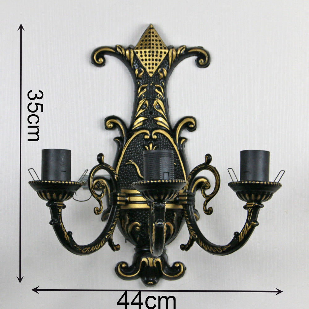 Decorative wall sconce with gold and black design, shown with measurements on a white background.