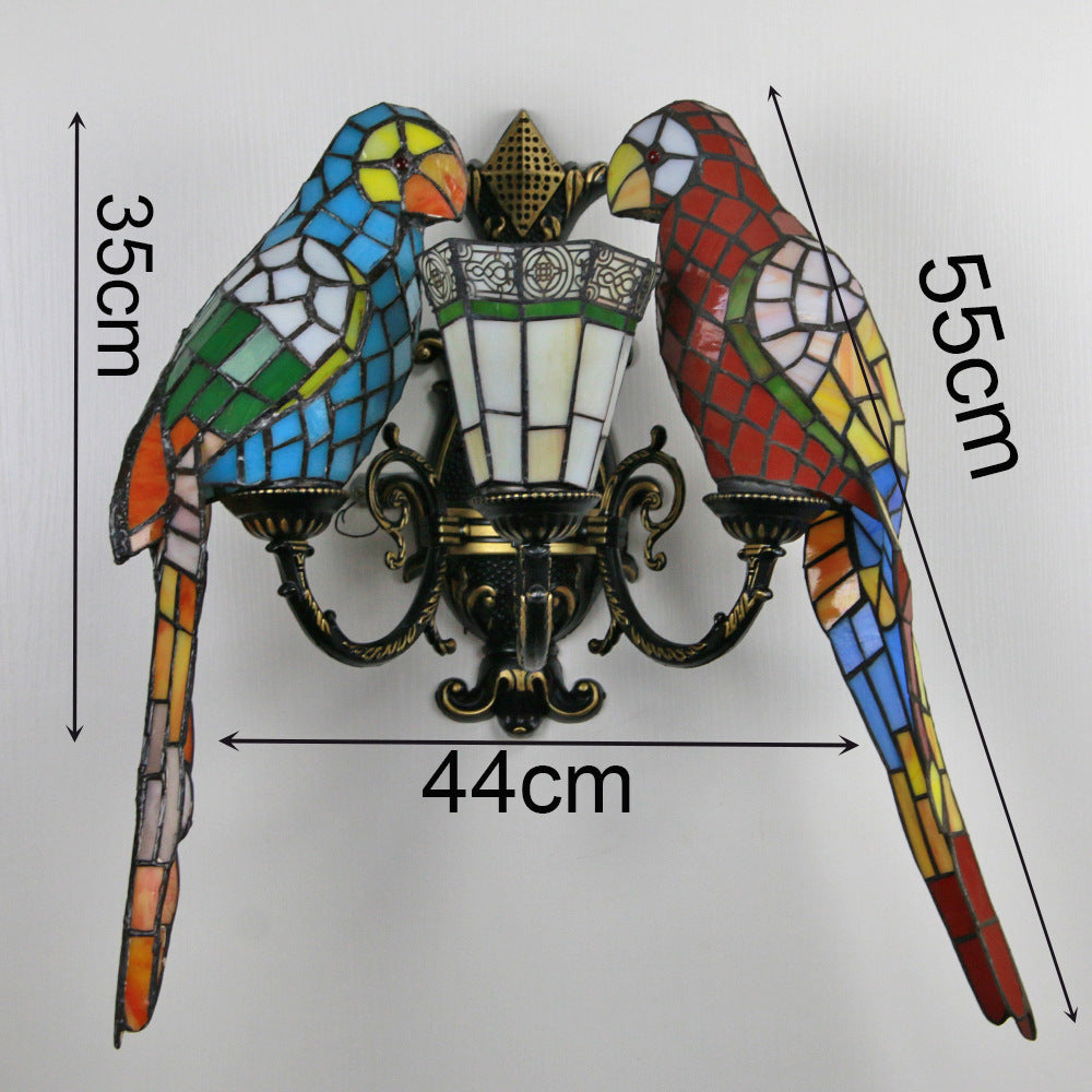Decorative wall light fixture with stained glass parrot design and measurements on a white background