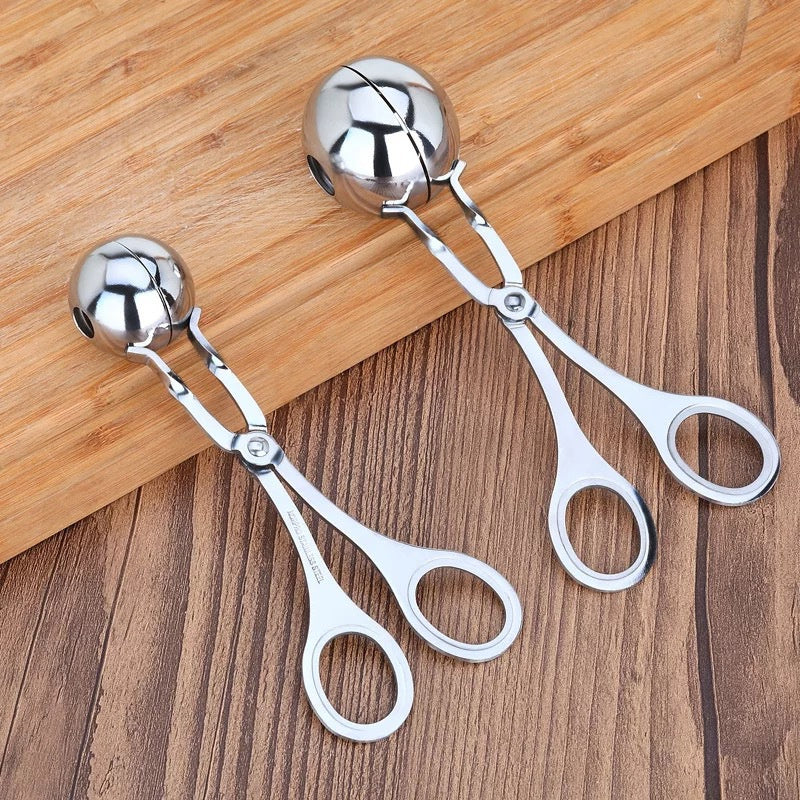 Two silver kitchen scissors on a wooden surface