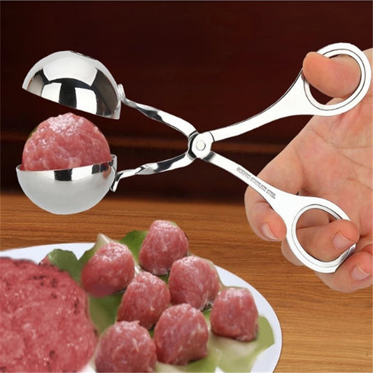 Metallic meatball maker being used to form meatballs on a wooden surface.