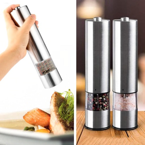 Silver salt and pepper shakers with a hand holding one, placed on a wooden surface.