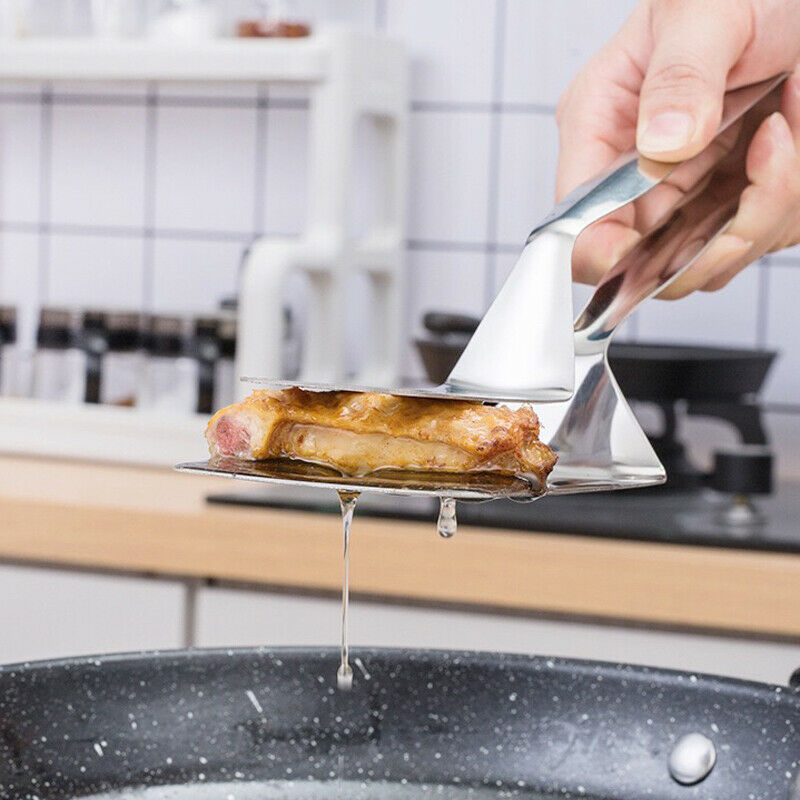 Person using a metal spatula to remove a piece of meat from a pan in a kitchen setting.