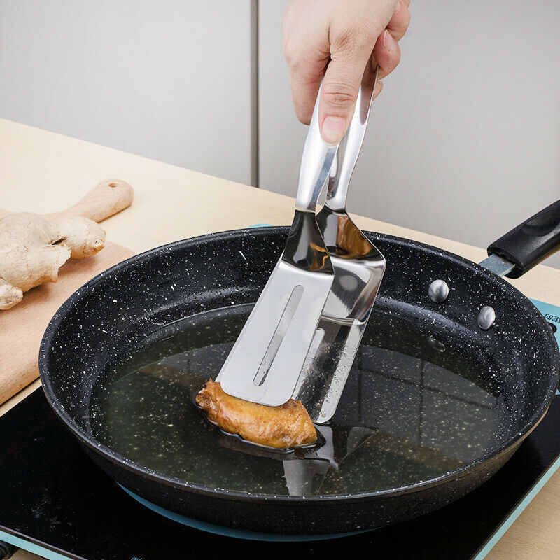 Person using a spatula to flip food in a frying pan on a stove.