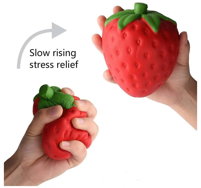 Strawberry-shaped stress reliever toy being squeezed by hands with text 'Slow rising stress relief'.