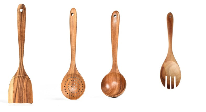 Set of four wooden kitchen utensils on a white background