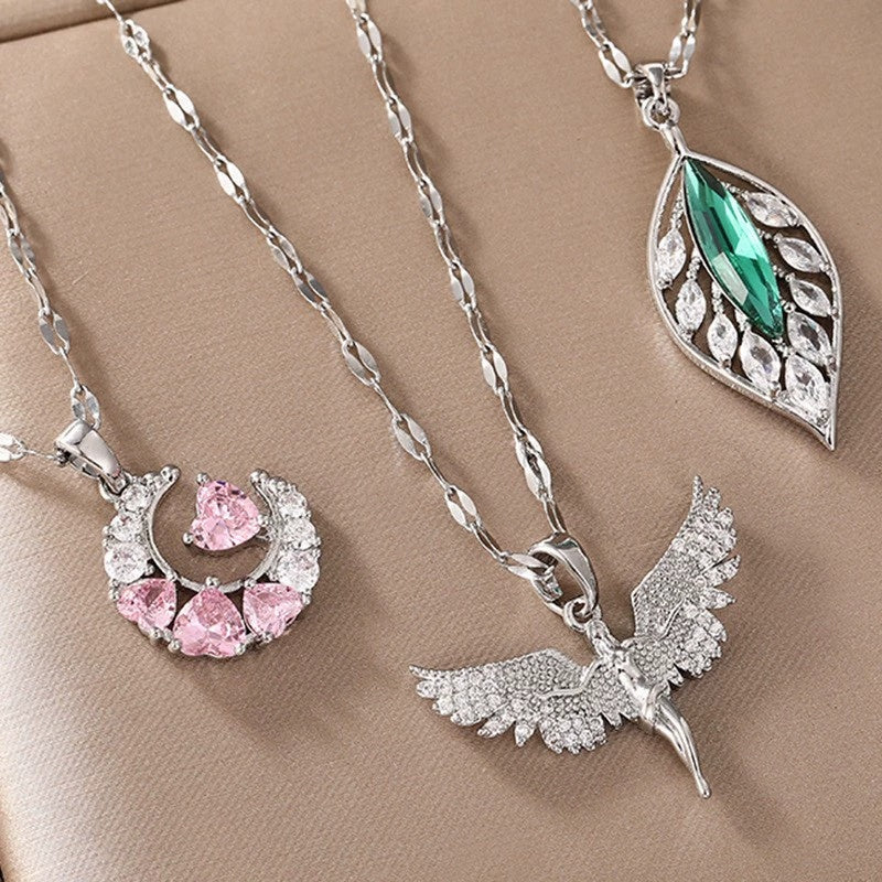 Three silver pendants on a beige background