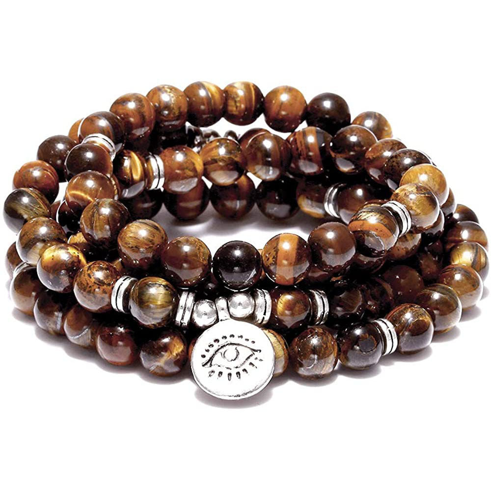 Stack of brown beaded bracelets with a silver charm on a white background