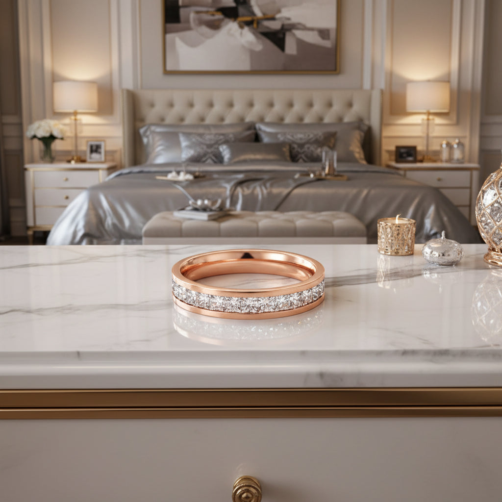 Rose gold ring with embedded diamonds on a white background