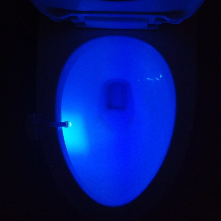 Glowing blue light on a white surface against a dark background