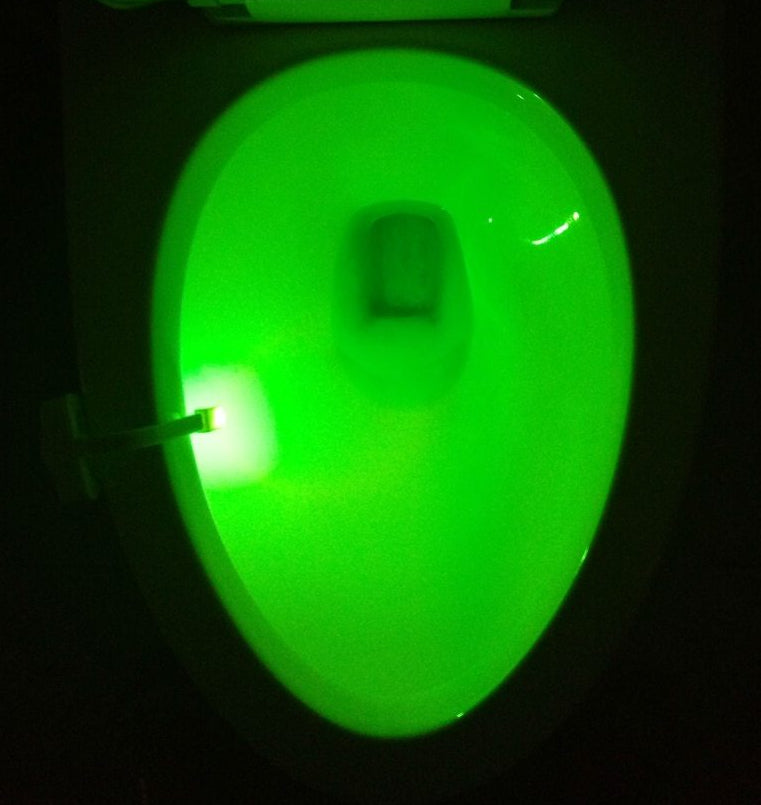Toilet seat glowing green in the dark