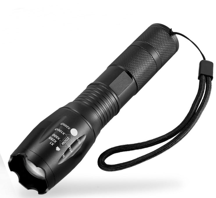 Black flashlight with adjustable focus on a white background