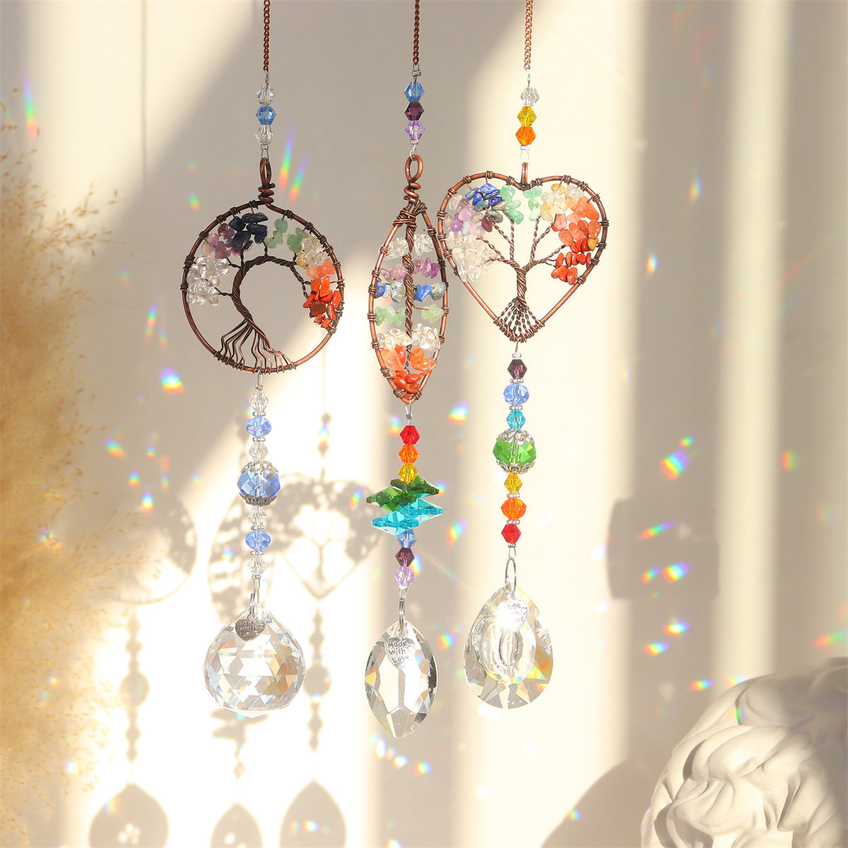 Decorative hanging ornaments with crystal elements and colorful beads on a soft background.