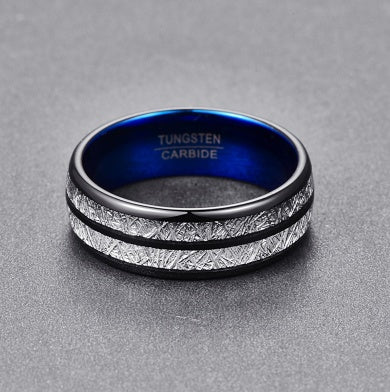 Tungsten carbide ring with blue interior and textured band on a gray background