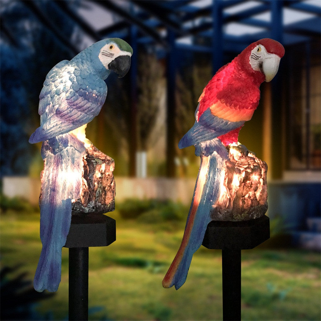 Two parrot-shaped garden lights on stakes with a blurred outdoor background.
