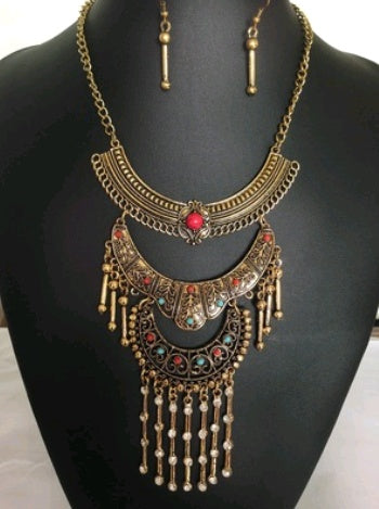 Ornate necklace with colorful stones on a black mannequin