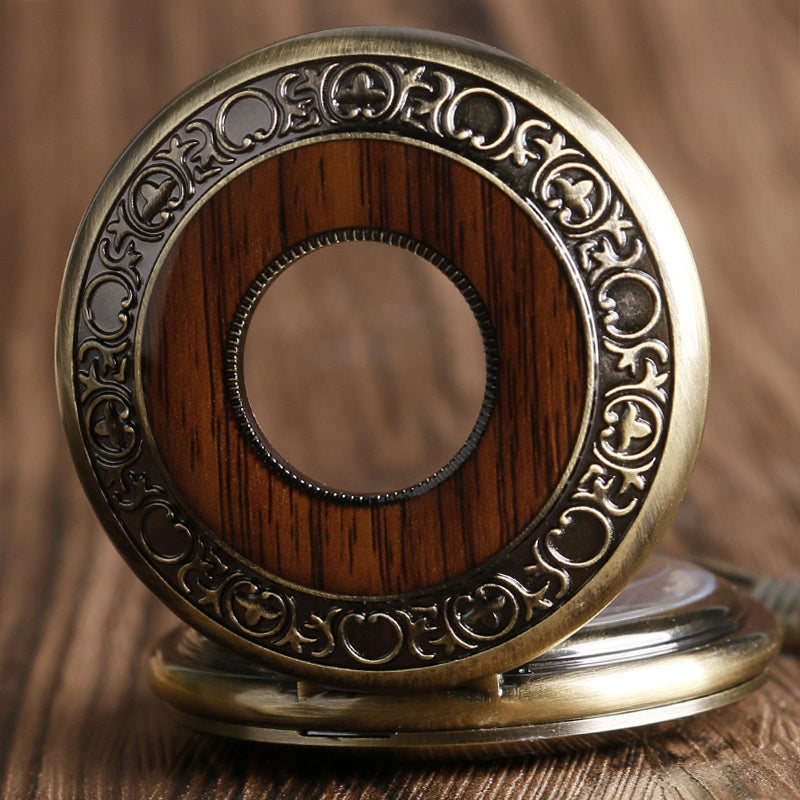Decorative compact mirror with wooden center and brass frame on a wooden surface