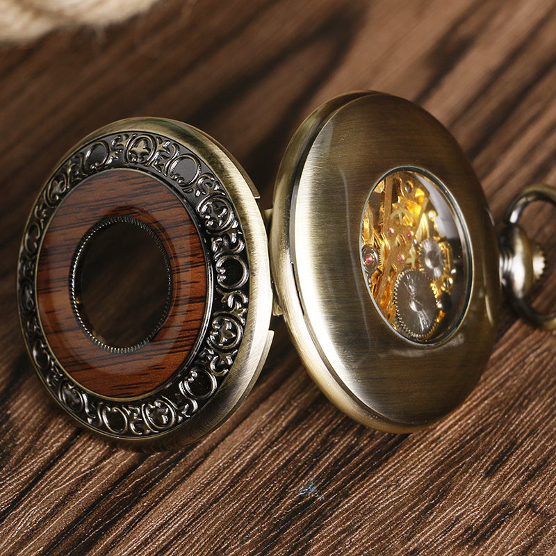 Close-up of a decorative pocket watch on a wooden surface