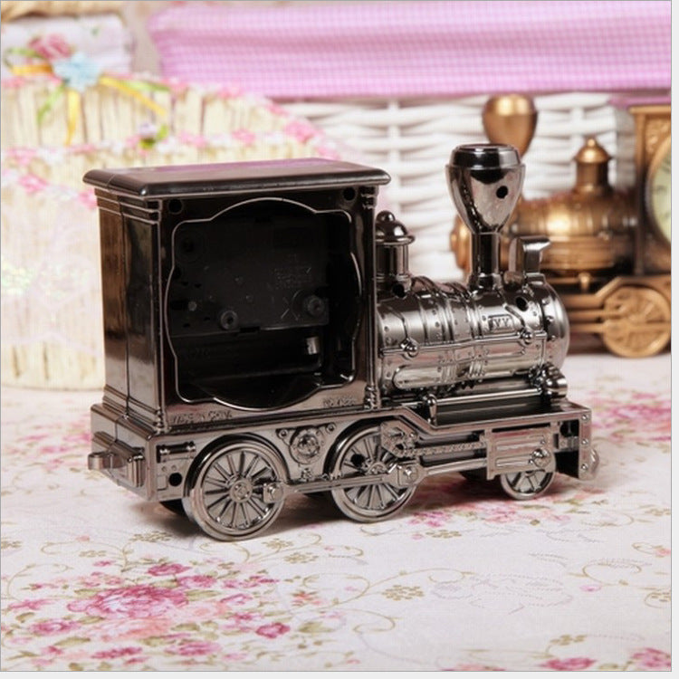 Vintage-style toy train model on a floral surface with decorative background