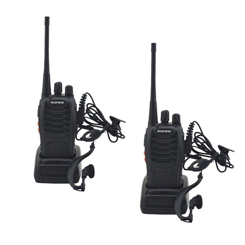 Two black walkie-talkies with earpieces on a white background