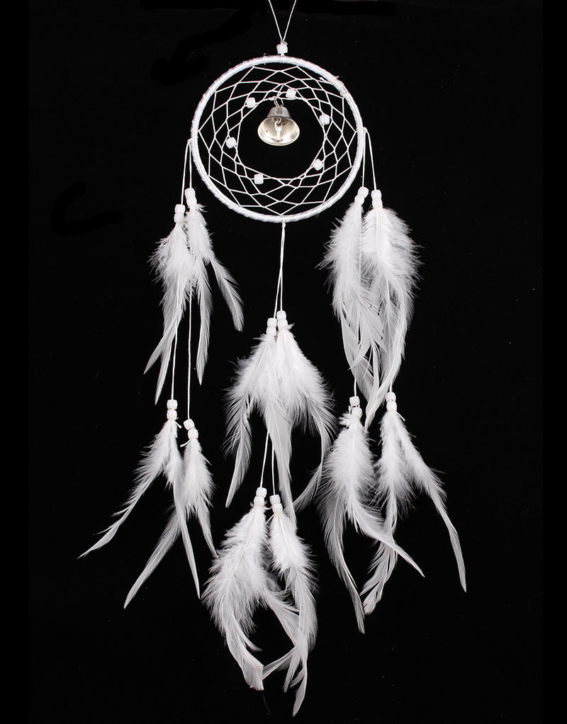 White dreamcatcher with feathers on a black background