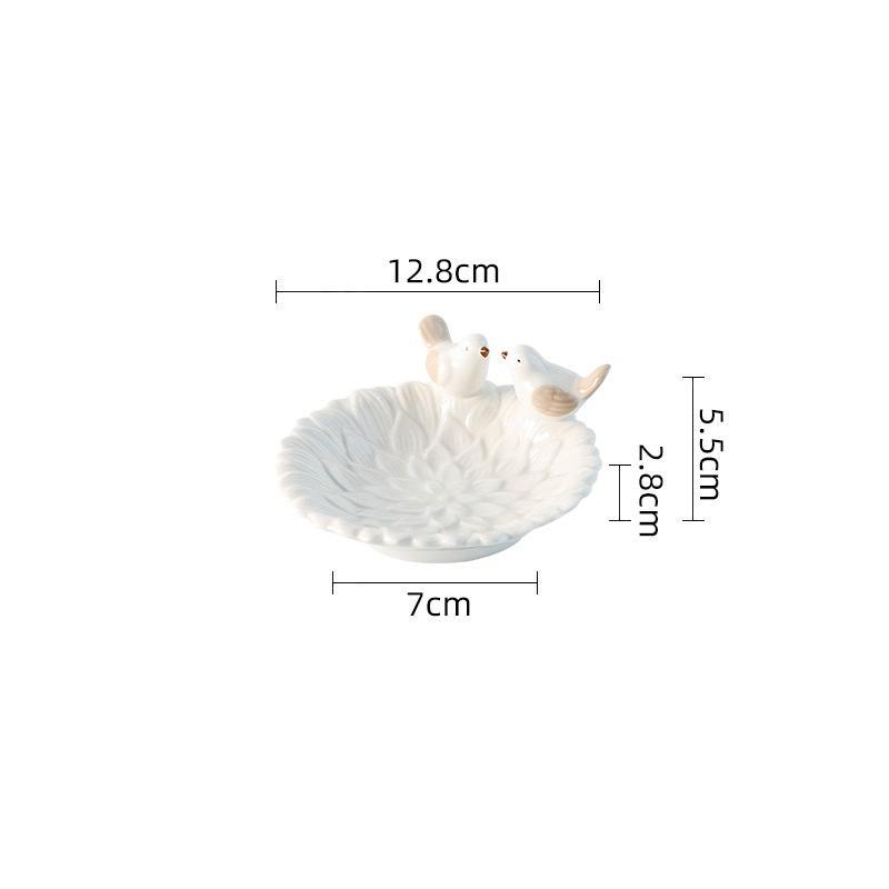 White ceramic seashell with two small white birds on a white background, showing measurements.